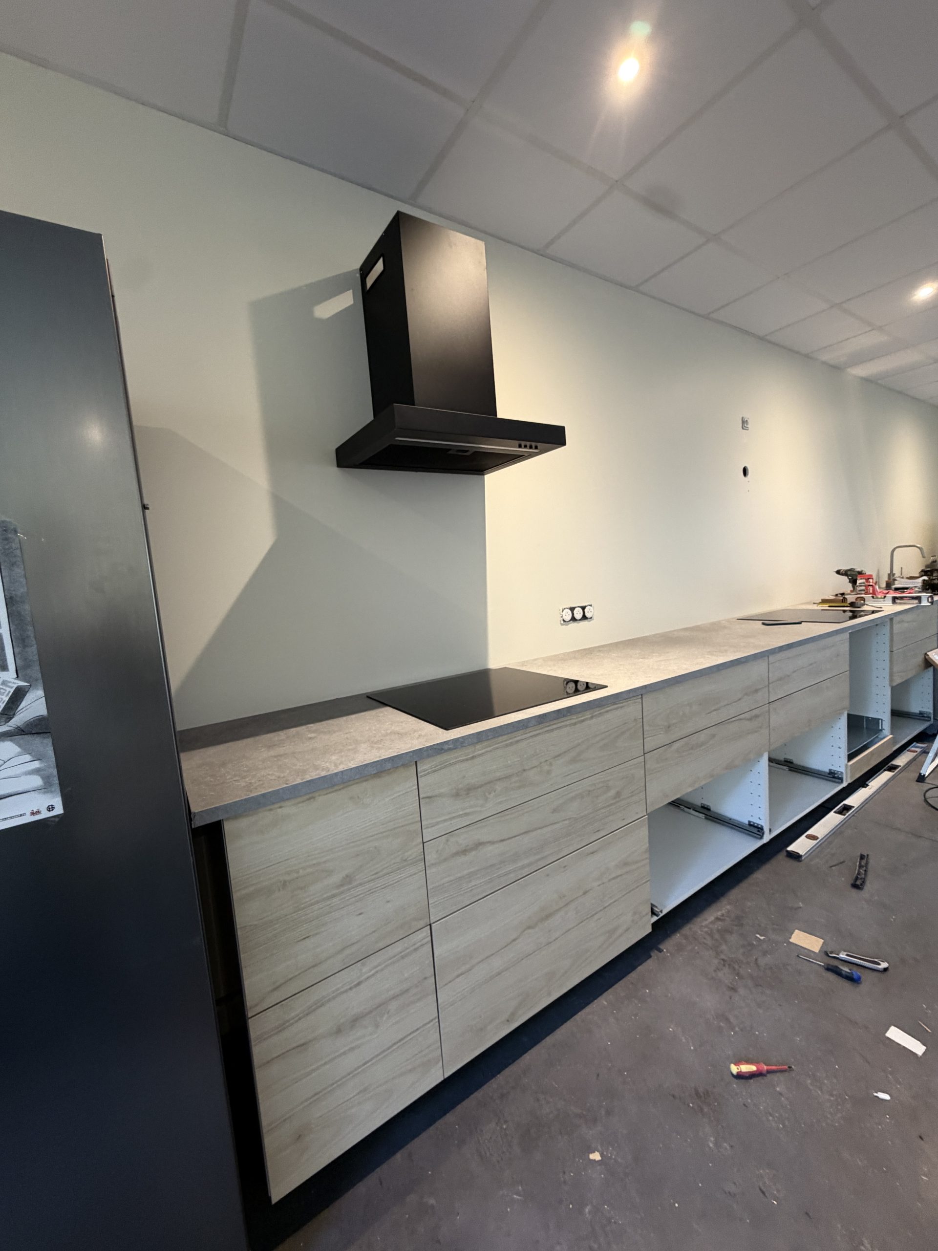 Montage d'une hotte aspirante au-dessus de la plaque de cuisson